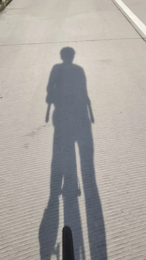 Shadow of A Man Cycling Stock Footage 308133134