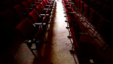 Shadow of a man in a dark , scary, old movie theater approaching towards camera 動画素材 75134494