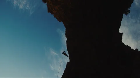 Shadow Of Man Descending Cliff Stock Footage 275482442