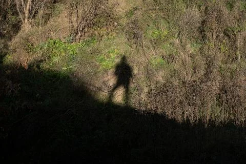 The shadow of a man in the distance looking down. The shadow of a man at th.. Stock Photos