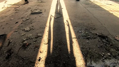 Shadow of a man entering spooky, abandoned building in sunset Stock Footage 89228520