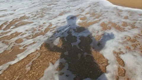 The shadow of a man in the foam of the waves Stock Footage 171381488