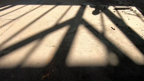 Shadow of a man moving toward in spooky, abandoned building Stock Footage 88285143