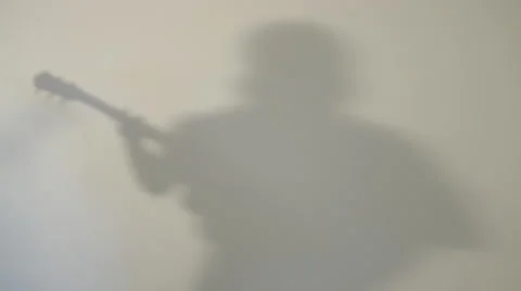 Shadow of man playing guitar Stock Footage 68651819