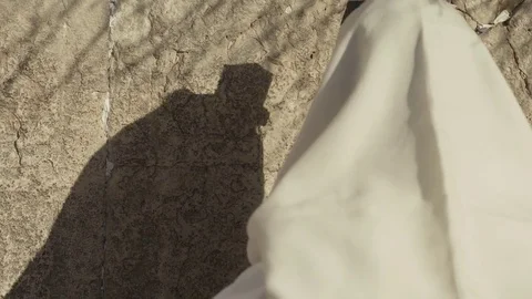 A shadow of a man Pray at the Western Wall in Jerusalem Video stock 83377197
