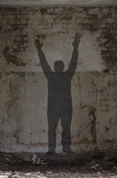 Shadow of a man with raised hands. 스톡 사진