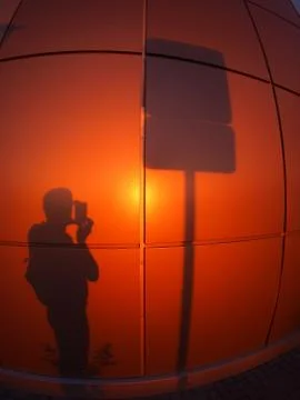 The shadow of a man on a red-orange wall Stock Photos