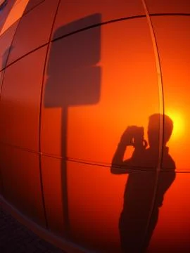 The shadow of a man on a red-orange wall Stock Photos