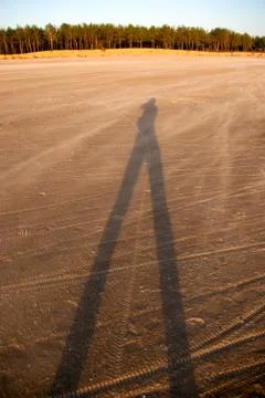 Shadow of a man on sand Stock Photos