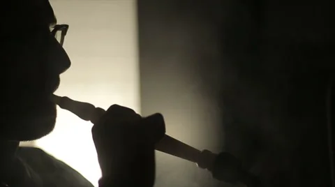 Shadow of a man smoking a hookah Видео 47245872