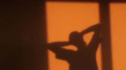 Shadow of man stretching back and neck at morning Stock Footage 57616335
