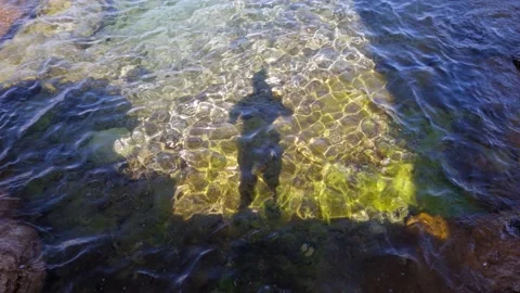 The shadow of a man on the surface of the sea. Video stock 160551665