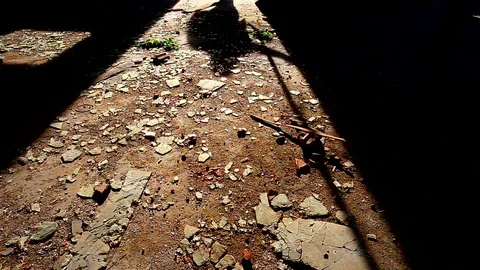 Shadow of a man walking away from some spooky building and closing door behind Stock Footage 82793563