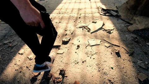 Shadow of a man walking away in spooky, abandoned building in sunset. Rear view. Stock Footage 89790774