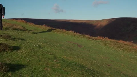 The shadow of a man walking a countryside trail on the Long Mynd Stock Footage 258453044