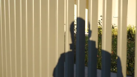 shadow man walking projected on railing | Stock Video | Pond5