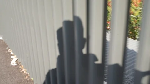 shadow man walking projected on railing | Stock Video | Pond5