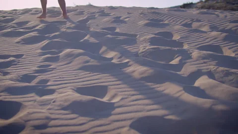 Shadow of Man Walking on Sand Dune at Sunset Video stock 334837083