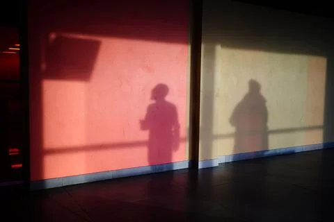 The shadow of a man on the wall, a man watching the departure screen Stock Photos