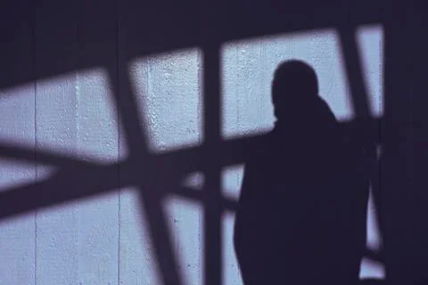 A shadow of a man on the wall Stock Photos