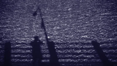 The shadow of a man in the water in the moonlight. Stock Footage 121100231