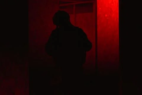 Shadow of a man with a weapon in the twilight Stock Photos