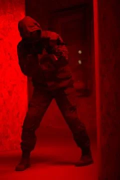 Shadow of a man with a weapon in the twilight Stock Photos