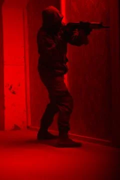 Shadow of a man with a weapon in the twilight Stock Photos