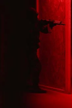 Shadow of a man with a weapon in the twilight Stock Photos