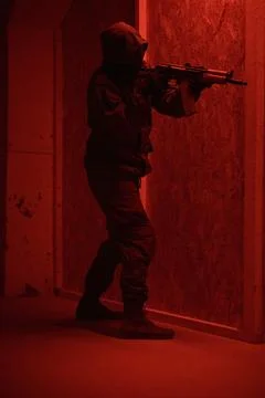 Shadow of a man with a weapon in the twilight Stock Photos