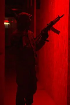 Shadow of a man with a weapon in the twilight Stock Photos