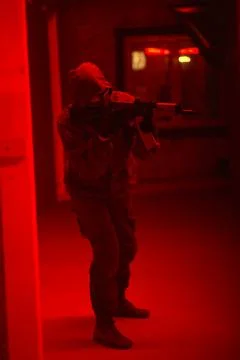 Shadow of a man with a weapon in the twilight Stock Photos