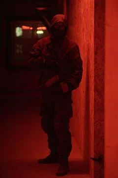 Shadow of a man with a weapon in the twilight Stock Photos