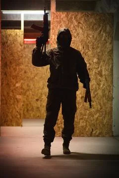 Shadow of a man with a weapon in the twilight Stock Photos