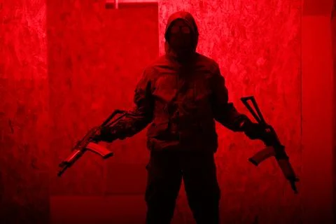 Shadow of a man with a weapon in the twilight Stock Photos