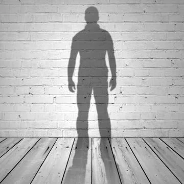 Shadow of a man on white brick wall and wooden floor Foto stock