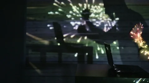 The shadow of a man working at a computer Stock Footage 99041915