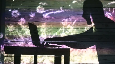 The shadow of a man working at a computer Stock Footage 99042404