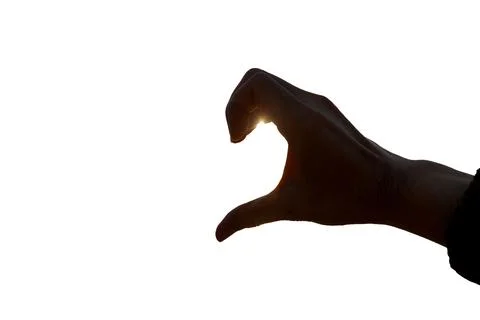 Shadow of a man's hand with a heart shape on a white background. Stock Photos
