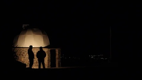 Shadow of men at night, talking or waiting Stock Footage