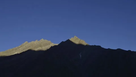 Shadow of mountain moving with setting sun seen at Pin Valley, Himachal Pradesh Stock Footage 320887326