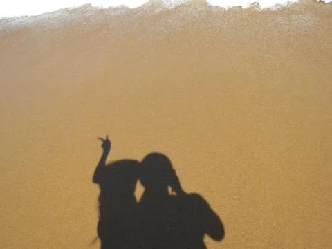 Shadow of a pair of lovers on a sand background Stock Photos