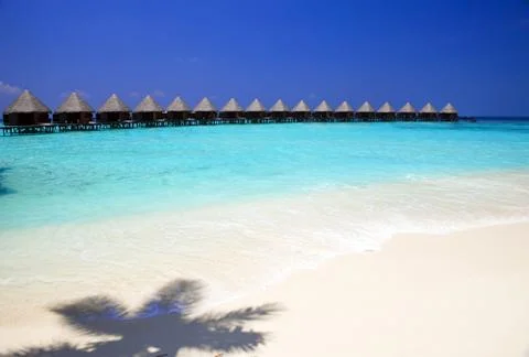 Shadow from palm tree and villa in ocean. .Maldives Stock Photos