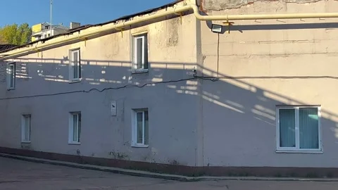 The shadow of a passing subway train on the sunny wall of the building. Stock Footage 162492481