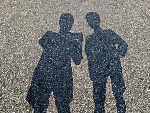 Shadow people on road surface Stock Photos
