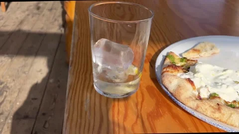 Shadow of person moving over the table with a partially eaten pizza at the resta Stock Footage 334085305