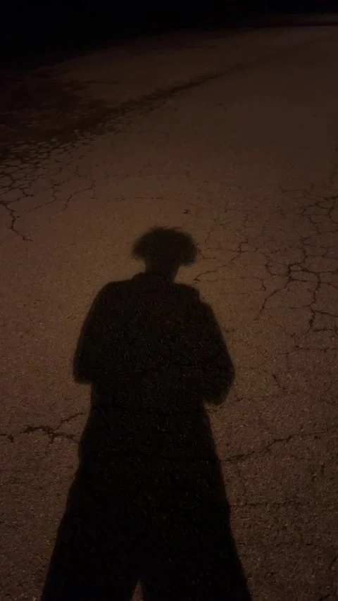 Shadow of person standing in front of a tripod at night Video stock 196221015