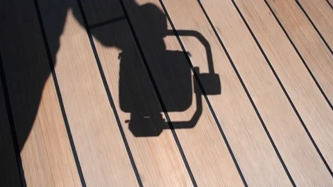 Shadow of a person walking with a hand held gimbal Stock Footage 101854003