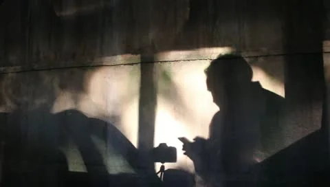 Shadow of Photographer Checking Smartphone for Next Assignment Stock Video Stock Footage