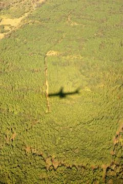 The shadow of the plane on the ground when landing over the jungle Stock Photos